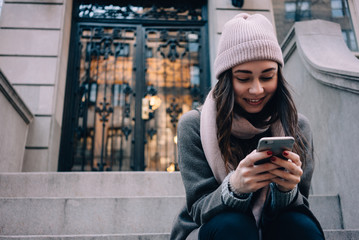 Close up portrait of a young girl using mobile phone