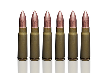 Bullets from kalasnikov rifle ammunition closeup isolated on white background.
