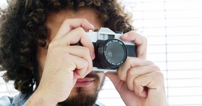 Photographer taking photo with vintage camera in studio 4k