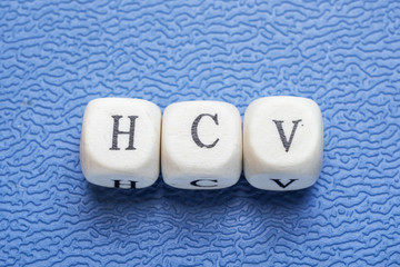 Word hsv (hepatitis c virus) on a wooden cubes on a blue background