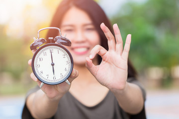 Times is OK or Right time with right job concept, Asian women hand show clock times with hand show...
