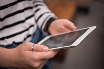 female hands working with tablet computer