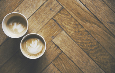 Two coffees on a floor background and a warm atmosphere