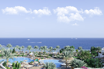 amazing view on the sea and shore with pools and palm trees