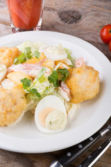 Caesar salad served on wooden table
