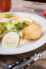 Caesar salad served on wooden table