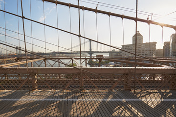 Empty Brooklyn Bridge pedestrian footpath in the morning sunlight