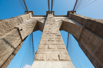 Brooklyn Bridge pillar low angle view, blue sky in New York