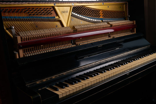 mechanics inside of an old upright piano