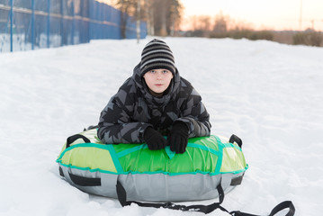 Teenager lying on green tubing