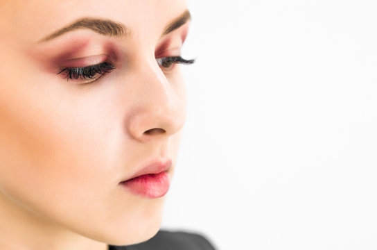 Woman with natural make-up eyes and lips looking to the side. Close-up
