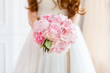 Bridal bouquet beautiful of pink wedding flowers in bride hands