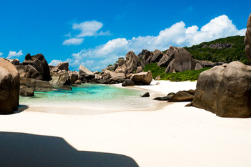 Natural pool on a tropical beach with huge rocks , Anse Marron, La digue, Seychelles