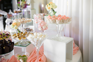 Large cocktail glass with marshmallow and little bowl with macar