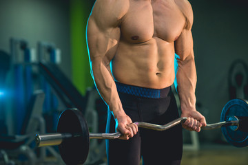 Fototapeta na wymiar Fitness model lifting weights