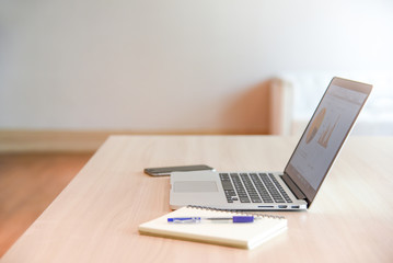 Business laptop on wooden office desk