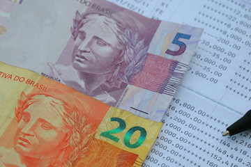 Brazilian Real banknote on bank statement, saving investment concept