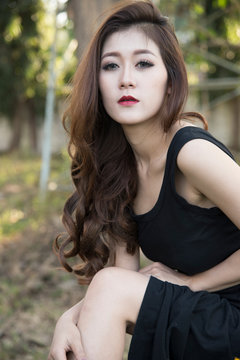 Beautiful asian woman in black dress.