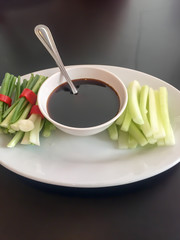 Sweet soy sauce in a bowl with vegetables