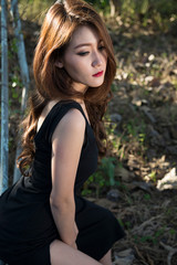 Beautiful asian woman in black dress.