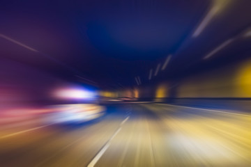 Fototapeta na wymiar police car with lighting while running in tunnel.-blurred.