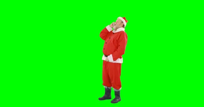 Santa claus talking on mobile phone against green background 4k