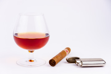 Cognac glass and cigar with lighter isolated on white background