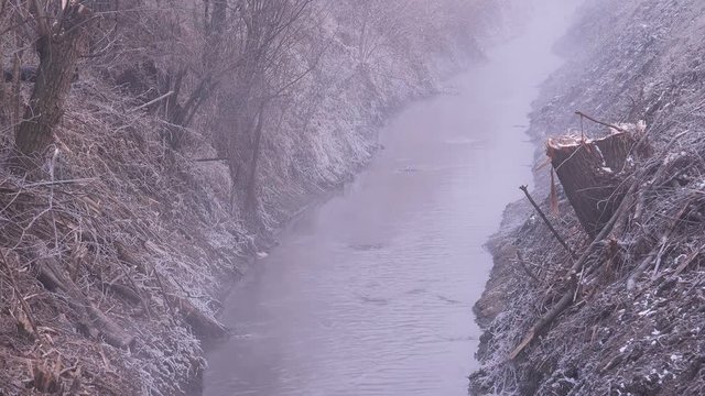 Wastewater channel on cold winter day, dirty smelly sewage and environmental pollution issue