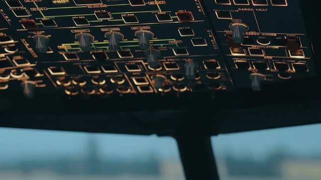 Close shot of overhead panel of modern aircraft with control buttons and knobs. Interior of Airbus A319 A320 A321 on the ground
