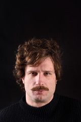 Fototapeta premium Portrait of an attractive man on black background