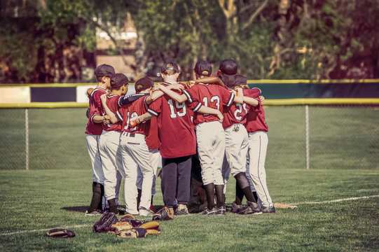 Baseball team in a huddle before a game.  Instgram toned image.