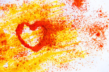 Valentine heart from spices curry and paprika on the white background