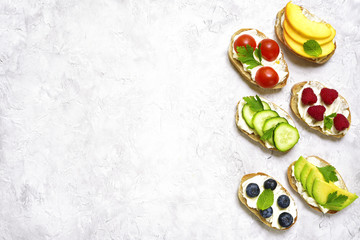 Assortment of fruit and vegetable toasts.Top view with space for