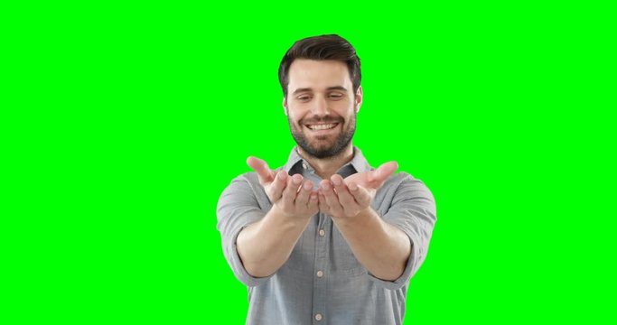 Man standing with his hands cupped against green background 4k