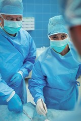 Team of surgeons performing operation in operation theater