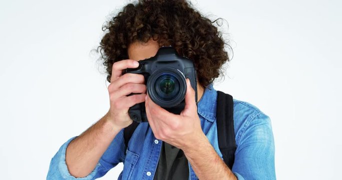 Photographer taking photo with professional digital camera in studio 4k
