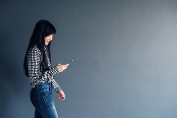 Happy Asian Woman Smile and Using Smart Phone while Walk