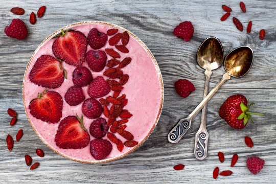 Pink Acai, Maca Powder Smoothie Bowl  Topped With Sliced Strawberries, Raspberries And Goji Berries. Flat Lay, Copy Space. Valentines Day Superfood Aphrodisiac Meal