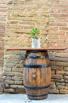 wooden barrel used as table on brick wall background