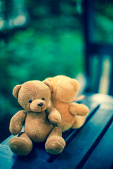 two bear dolls on the table with dramatic tone