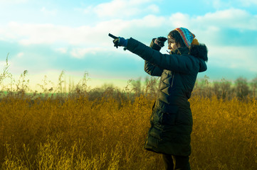 Woman in black pointing her finger towards blank space