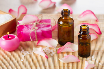 Obraz na płótnie Canvas Essential oil for aromatherapy,pink roses petals, handmade soap