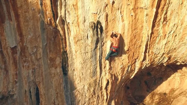 Rock climber climbing on the rock in Greece