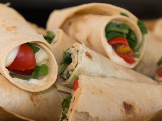 Italian Piadina Rolled and Filled with Cheese, Tomato and Argula