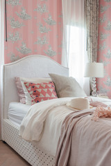 Fototapeta na wymiar pink color tone bedroom with classic bed style