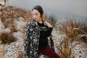 Young woman with floral jacket posing outdoors