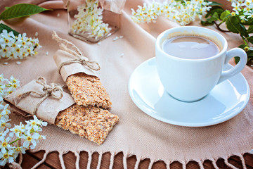 Cup of coffee and grain small loafs on a table