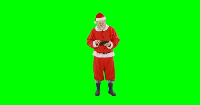 Santa claus using digital tablet against green background 4k