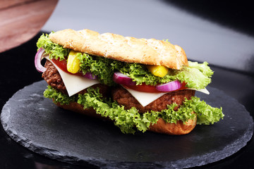 Tasty grilled prawn and beef burger with lettuce and tomato