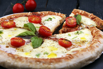 Hot true PEPPERONI ITALIAN PIZZA with salami and cheese. TOP VIEW Tasty traditional pepperoni pizza on board on wooden table with decoration